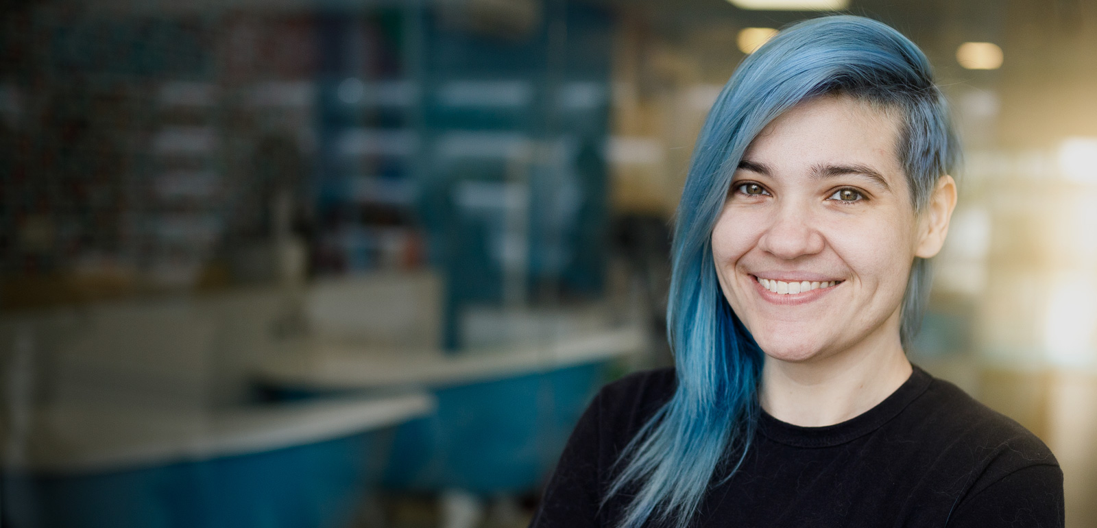 Woman with blue hair smiles
