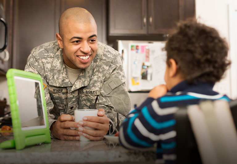 Veterans: a veteran hangs out with his son in the kitchen. 