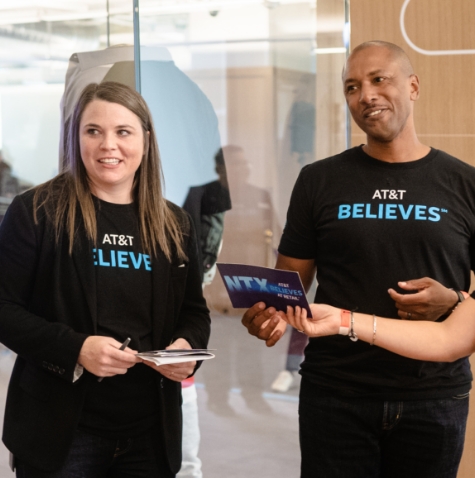 Two employees wearing AT&T Believes black t shirts.