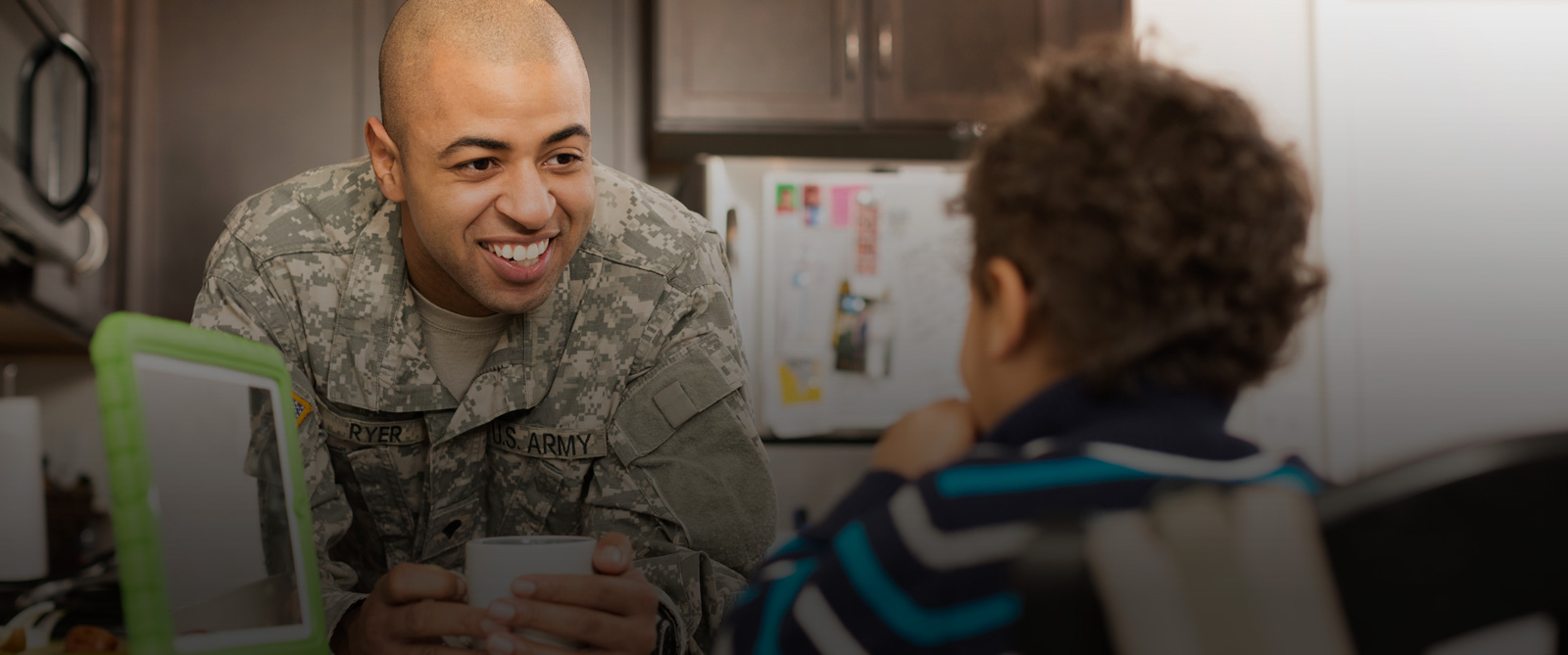 Veterans: a veteran hangs out with his son in the kitchen. 
