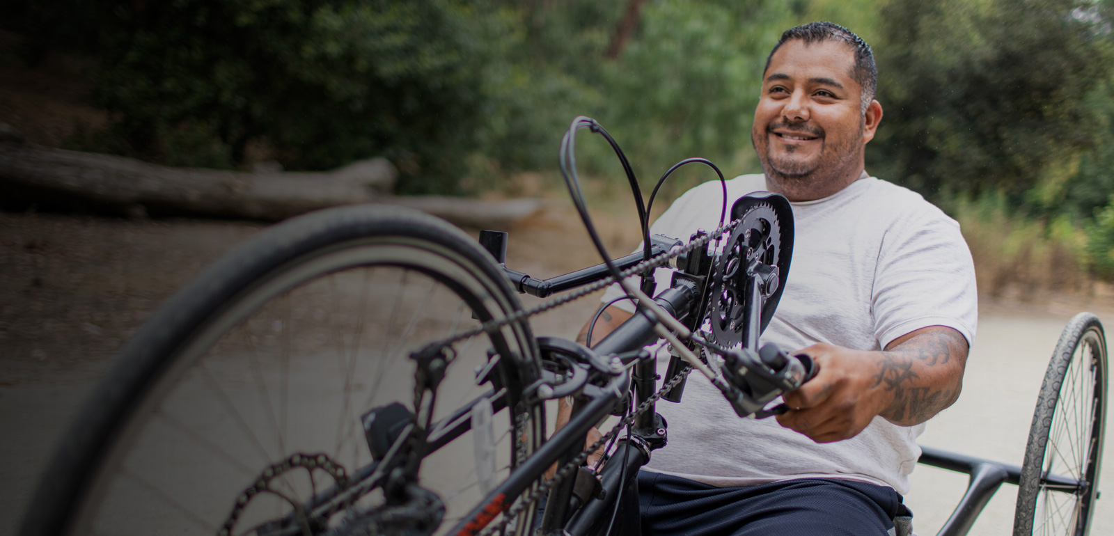 A man smiles while using a bike.