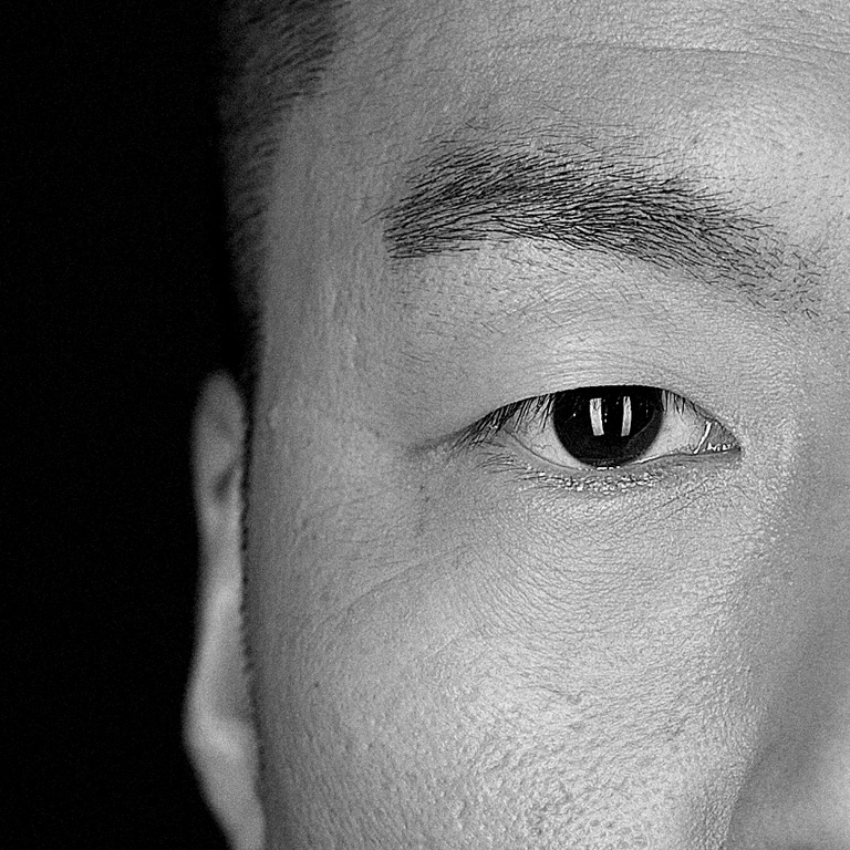Black and white close up photo of a mans face