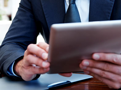 Man wearing a suit using a tablet