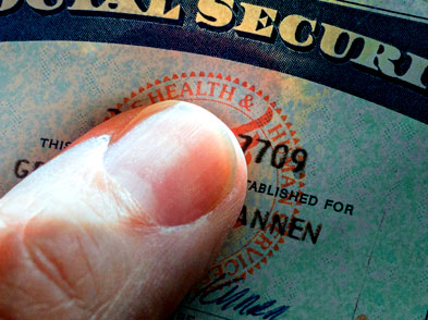 A person holding their social security card