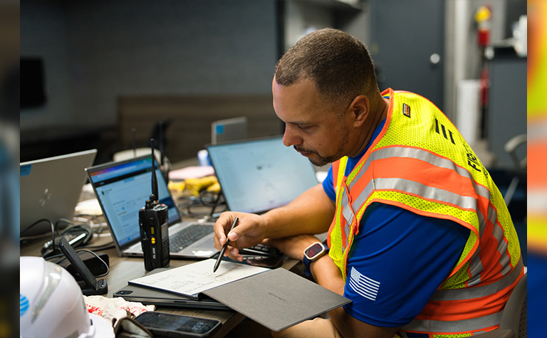 AT&T Network Disaster Recovery (NDR) support team member working inside command center at basecamp.