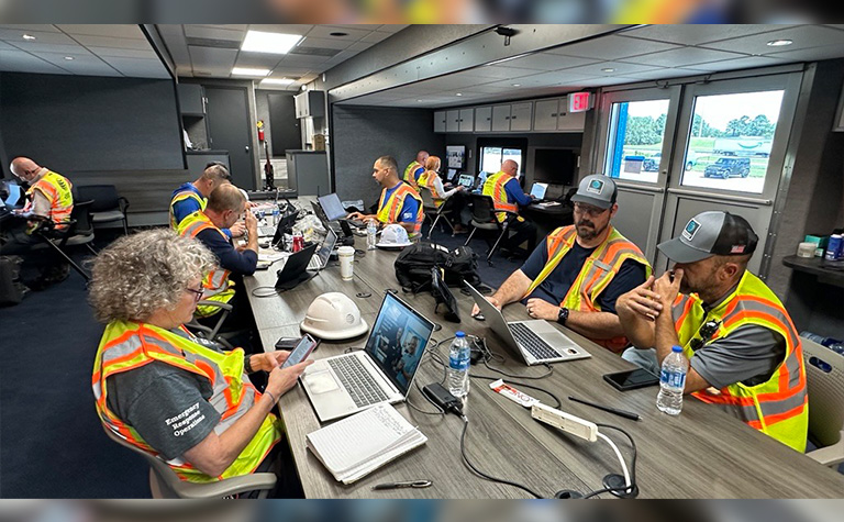 AT&T Network Disaster Recovery (NDR) support team members working in command center at basecamp.