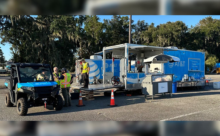 AT&T Network Disaster Recovery (NDR) support team members prep food trailer at basecamp.