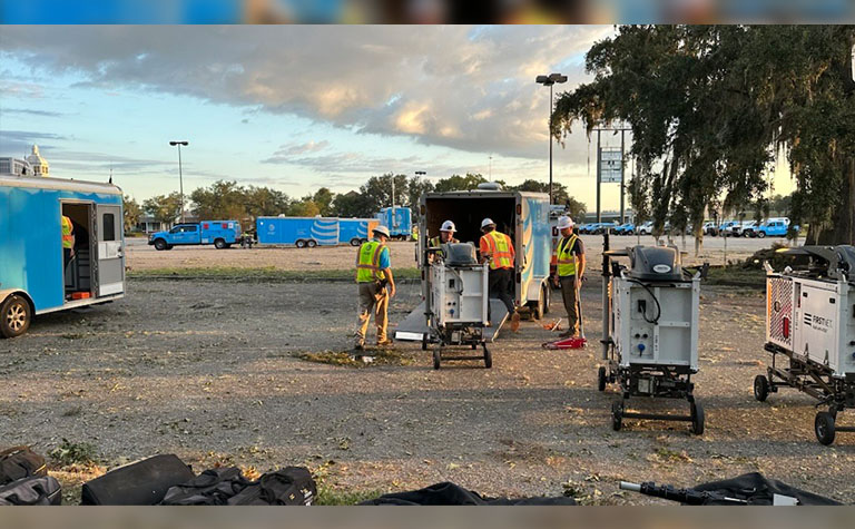 AT&T Network Disaster Recovery (NDR) support team members unloading FirstNet Compact Rapid Deployables (CRDs) at base camp in McIntosh County, GA