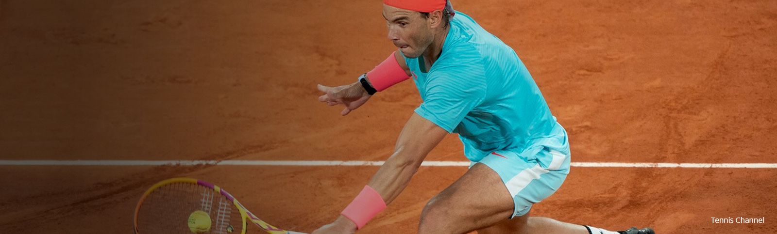 Rafael Nadal hits a backhand in a blue and orange tennis outfit