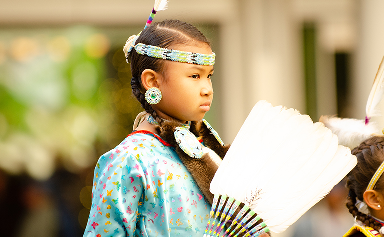 A child performs in celebration of Native American Heritage Month