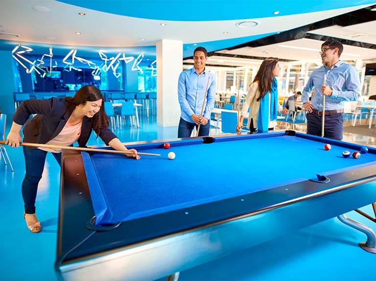 Employees socializing while playing pool