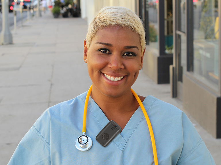 Nurse wearing AlertGPS device as a clip-on